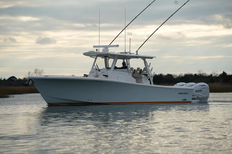 Slide: The Image of 2025 Regulator 37 boat on calm water under cloudy sky. - 6