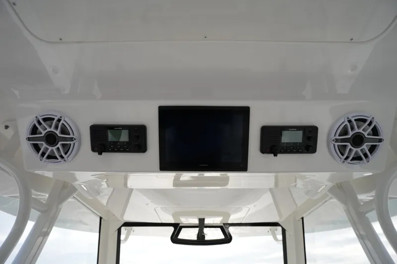 Slide: The Image of 2025 Regulator 37 boat dashboard with speakers, Garmin devices, and a central display screen. - 61