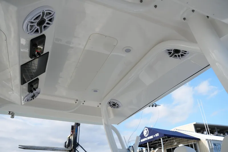 Slide: The Image of 2025 Regulator 37 boat ceiling with speakers and control panel, marina background. - 63