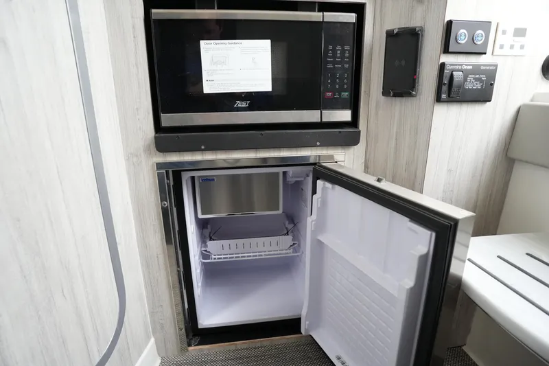 Slide: The Image of 2025 Regulator 37 interior with microwave and open mini fridge. - 71
