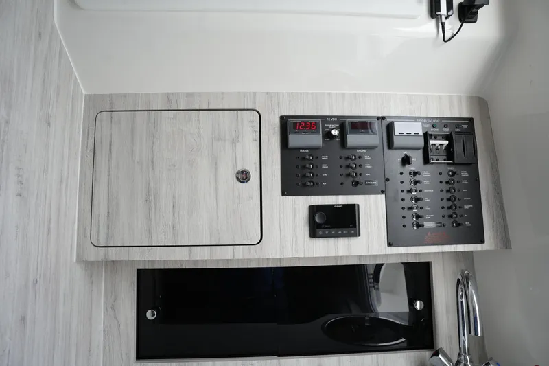 Slide: The Image of Control panel of 2025 Regulator 37 boat with switches and digital display. - 72