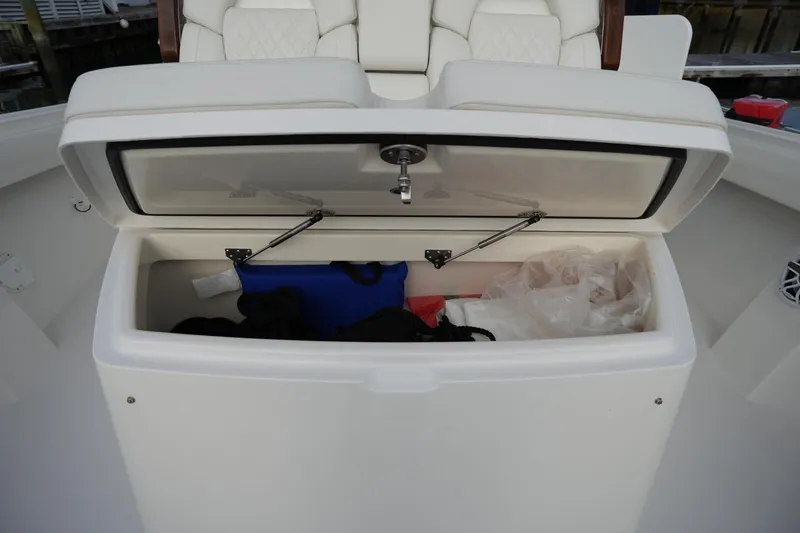 Slide: The Image of Open storage compartment on 2025 Regulator 37 boat, featuring cushioned seating. - 76