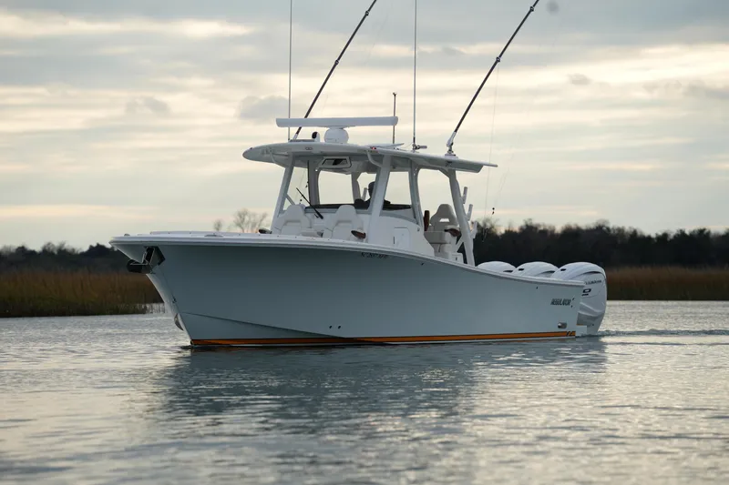 Slide: The Image of 2025 Regulator 37 boat on calm water, featuring dual outboard engines. - 8