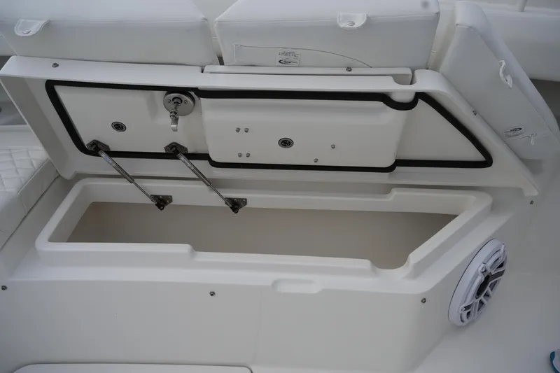 Slide: The Image of 2025 Regulator 37 boat storage compartment with open lid and speaker detail. - 81