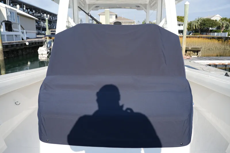 Slide: The Image of 2025 Regulator 37 boat with covered console, docked in marina. - 84