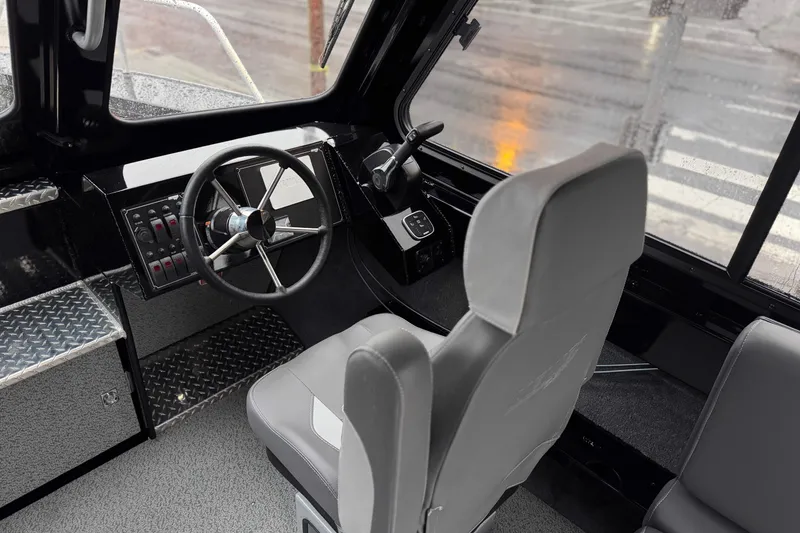 Slide: The Image of Interior of 2026 Hewescraft 240 Ocean Pro ET HT boat, featuring steering wheel and controls. - 6