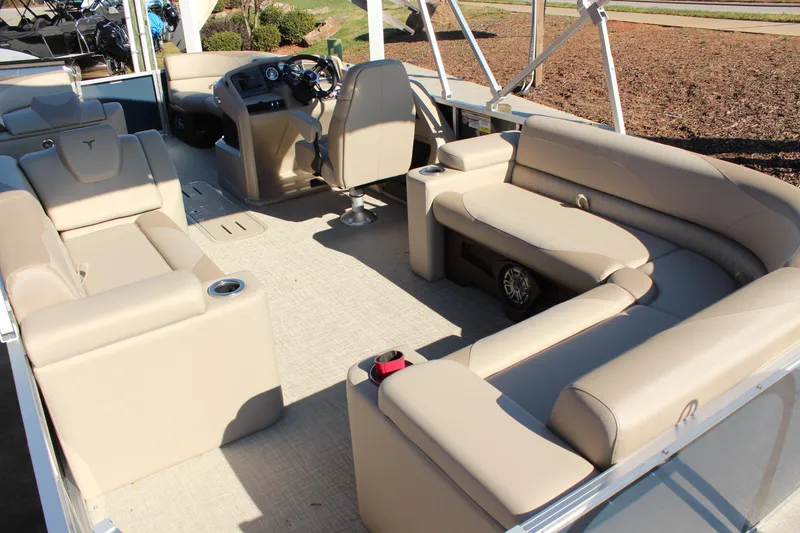 Slide: The Image of 2026 Tahoe Pontoon LTZ Elite interior with beige seating and modern dashboard. - 10