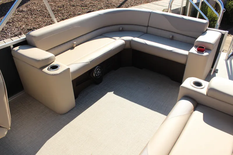 Slide: The Image of 2026 Tahoe Pontoon LTZ Elite interior with beige seating and cup holders. - 17