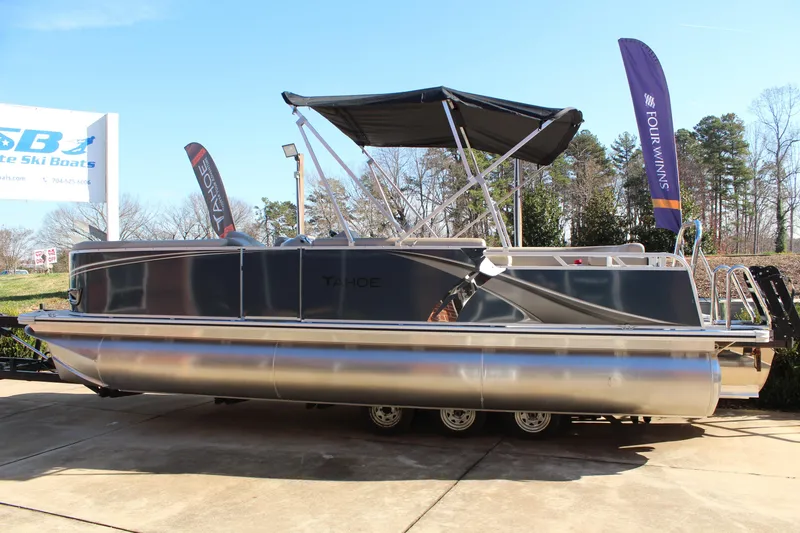 Slide: The Image of 2026 Tahoe Pontoon LTZ Elite boat displayed outdoors with canopy and banners. - 6