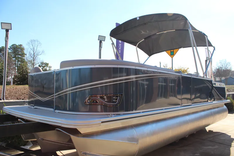 Slide: The Image of 2026 Tahoe Pontoon LTZ Elite boat with canopy, parked outdoors. - 7