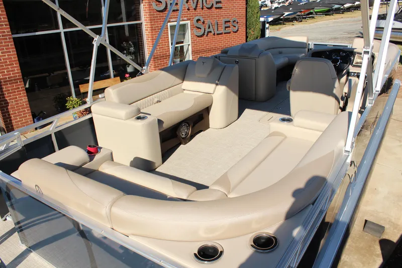 Slide: The Image of 2026 Tahoe Pontoon LTZ Elite with luxurious seating and modern design at a sales location. - 9