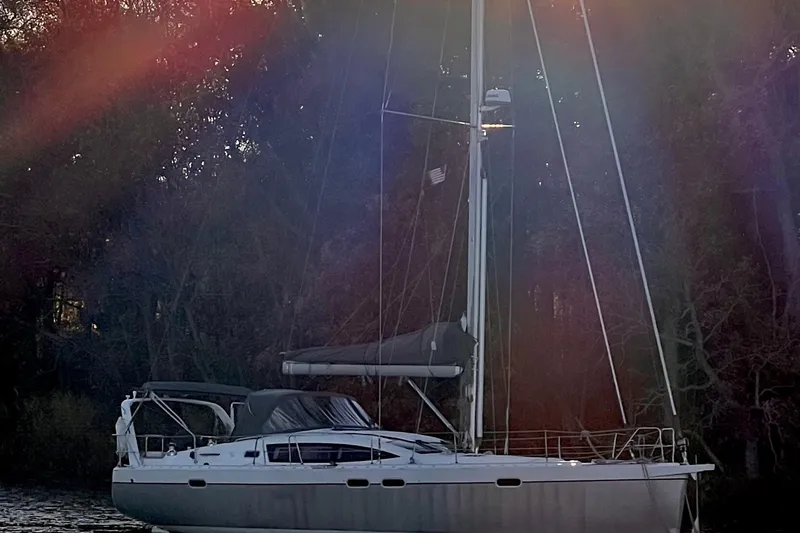 Slide: The Image of Sailing yacht Allures 45, 2011 model, anchored near a forested shoreline. - 10
