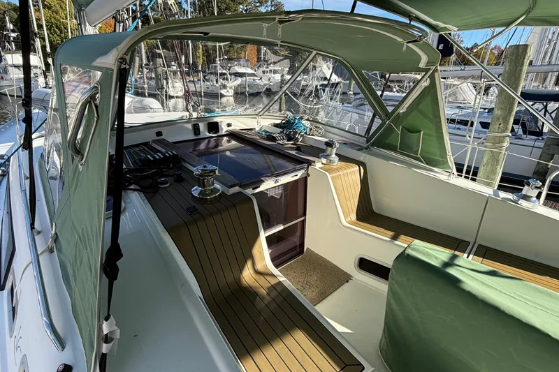 Slide: The Image of Cockpit of 2011 Allures 45 sailboat with green canopy and wooden seating. - 2