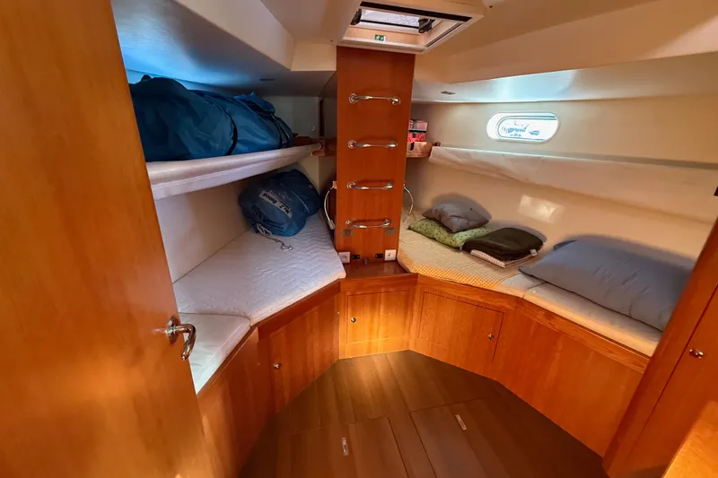 Slide: The Image of Cozy cabin interior of 2011 Allures 45 sailboat with wooden finishes and comfortable bedding. - 4
