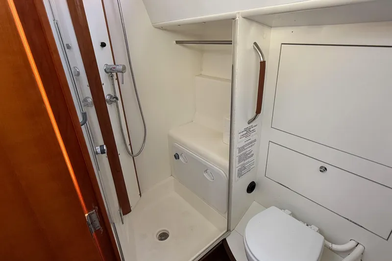 Slide: The Image of Allures 45 2011 yacht bathroom with shower and toilet, featuring white interior design. - 7