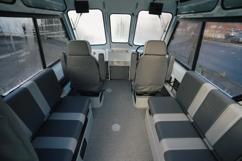Slide: The Image of Interior of 2026 Hewescraft 210 Sea Runner ET HT boat, featuring spacious seating and helm. - 4