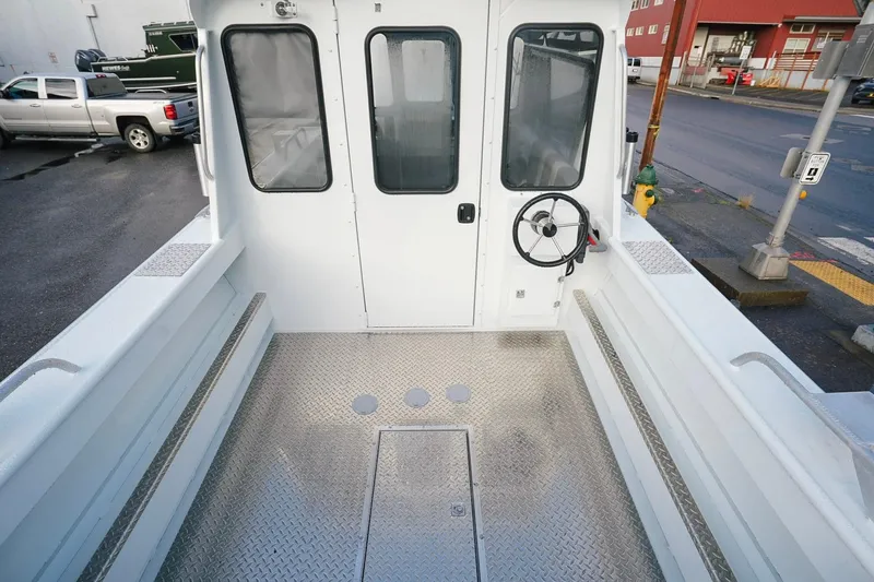 Slide: The Image of 2026 Hewescraft 210 Sea Runner ET HT boat interior with steering wheel and metal flooring. - 8