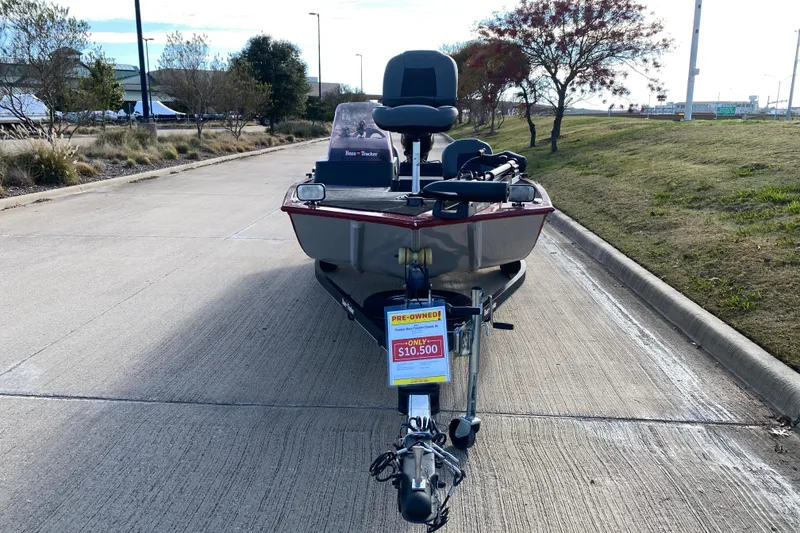 Slide: The Image of 2021 Tracker Bass Tracker Classic XL boat for sale, priced at $10,500, parked on a road. - 2
