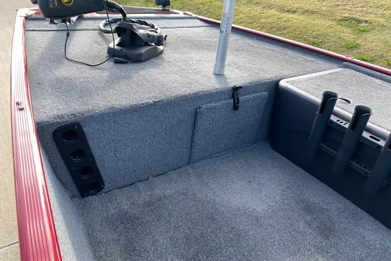 Slide: The Image of 2021 Tracker Bass Tracker Classic XL boat interior with rod holders and carpeted deck. - 9