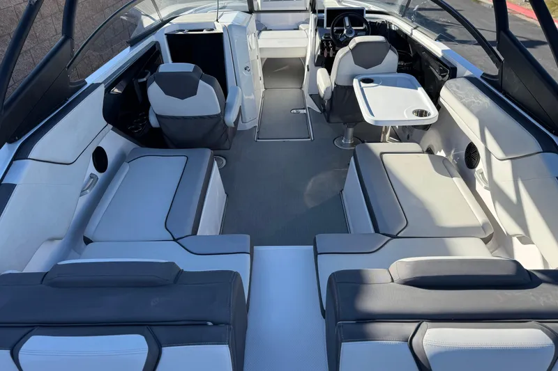 Slide: The Image of 2023 Yamaha Boats AR250 interior with modern seating and sleek design. - 10