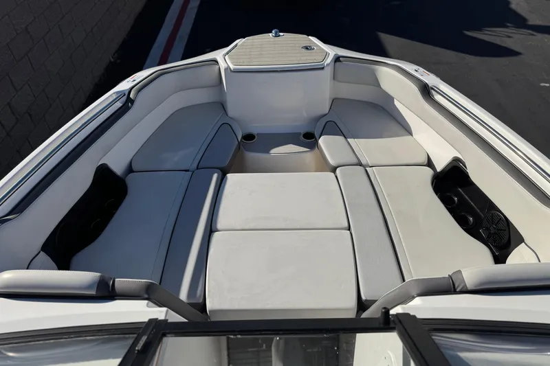 Slide: The Image of 2023 Yamaha Boats AR250 interior with spacious seating and modern design. - 11