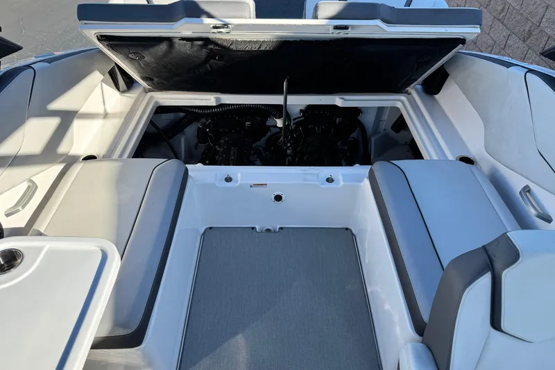 Slide: The Image of 2023 Yamaha Boats AR250 engine compartment with open hatch, showcasing interior design. - 18