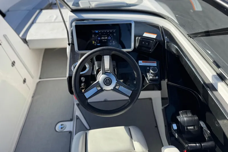 Slide: The Image of 2023 Yamaha Boats AR250 steering console with digital display and controls. - 26