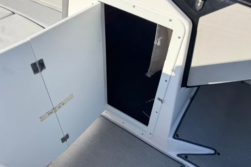 Slide: The Image of Open storage compartment on 2023 Yamaha AR250 boat, showcasing interior space. - 33