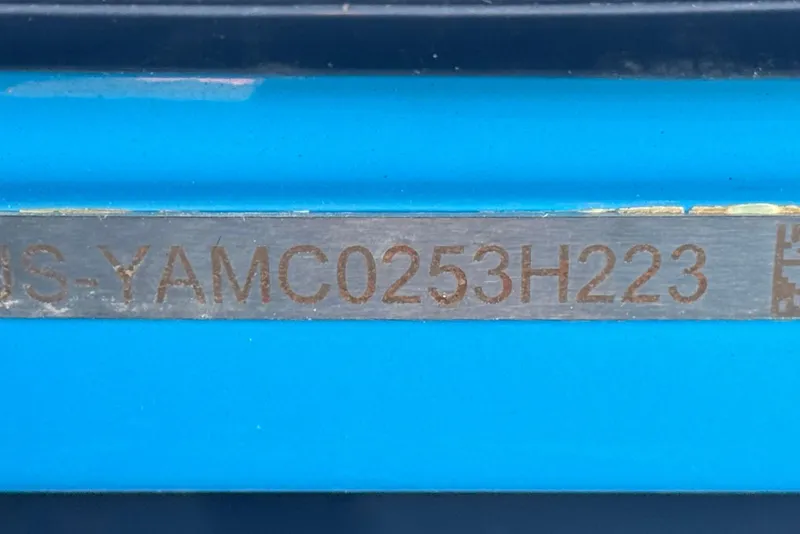Slide: The Image of Hull identification number on 2023 Yamaha Boats AR250, displayed on a blue surface. - 38