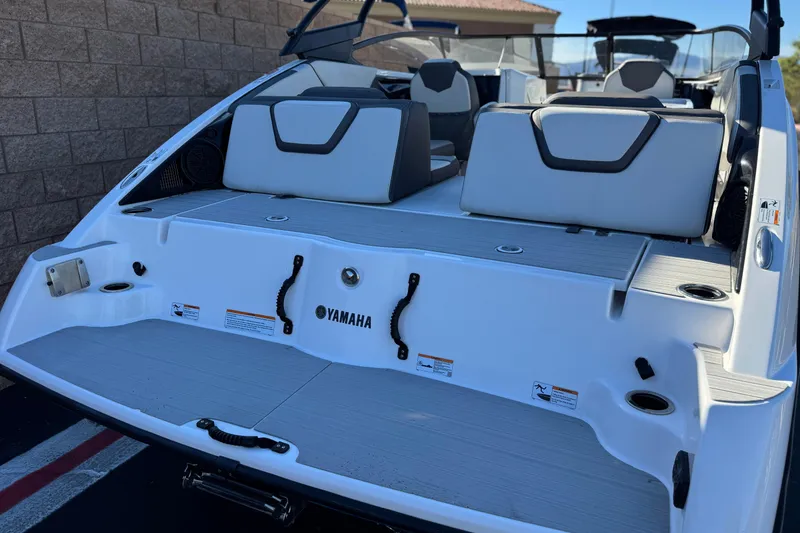 Slide: The Image of 2023 Yamaha Boats AR250, rear view showcasing seating and deck features. - 6