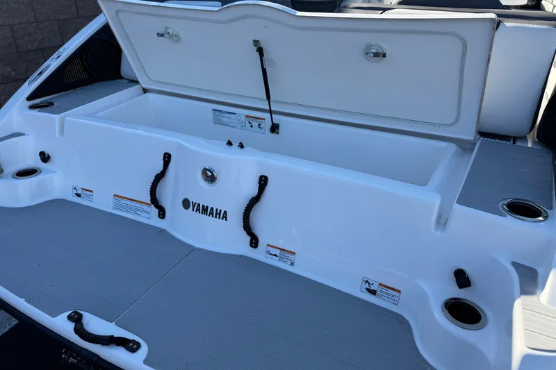 Slide: The Image of 2023 Yamaha Boats AR250 swim platform with storage compartment open. - 7