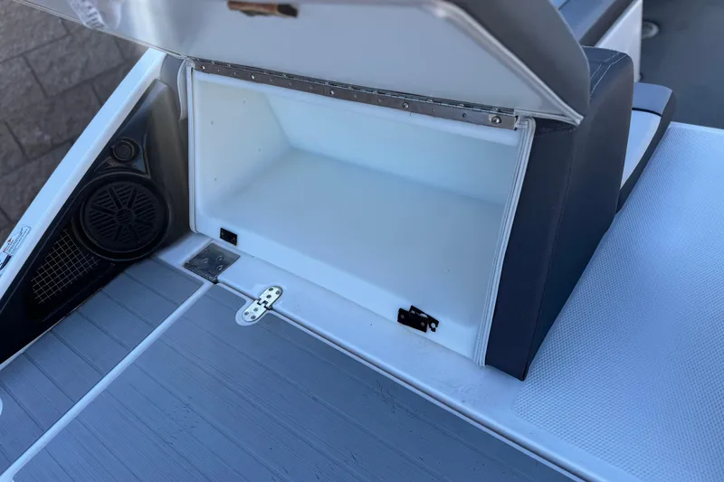 Slide: The Image of Open storage compartment on 2023 Yamaha AR250 boat with speaker detail. - 8