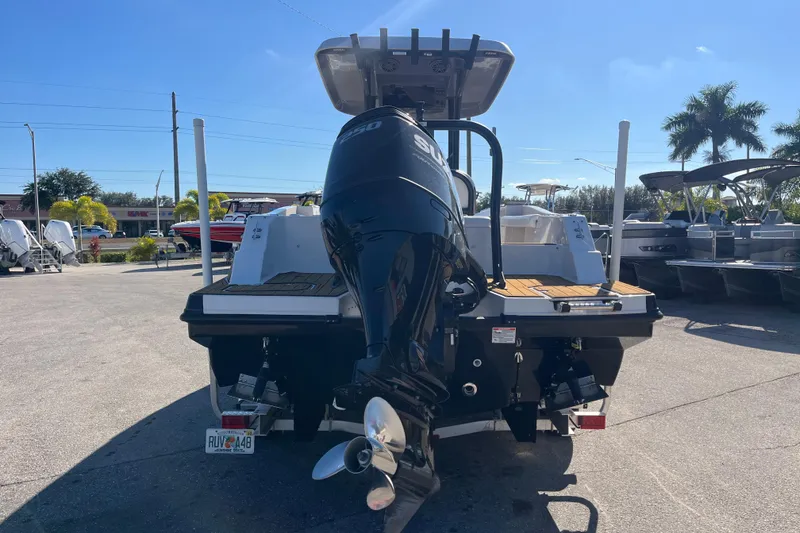 Slide: The Image of 2024 Starcraft SVX 231 OB CC boat with Suzuki outboard motor in sunny marina. - 5