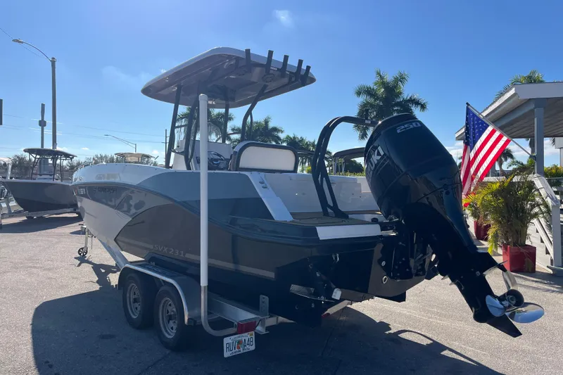 Slide: The Image of 2024 Starcraft SVX 231 OB CC boat with Suzuki outboard motor on trailer, sunny day. - 6