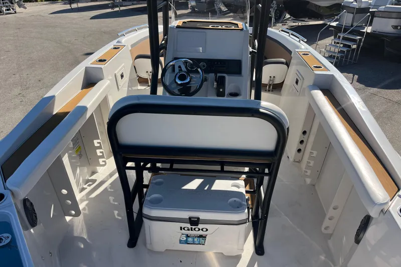 Slide: The Image of 2024 Starcraft SVX 231 OB CC boat interior with steering console and seating. - 8