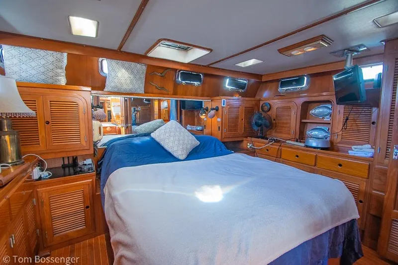 Slide: The Image of Luxurious 1985 Spindrift 40 yacht cabin with wooden interior and cozy bedding. - 13