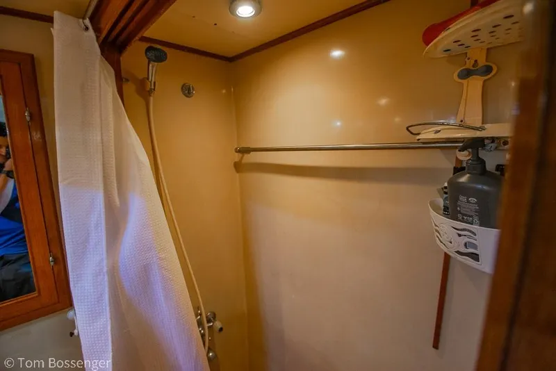 Slide: The Image of Shower area in 1985 Spindrift 40 yacht with curtain and storage shelf. - 18