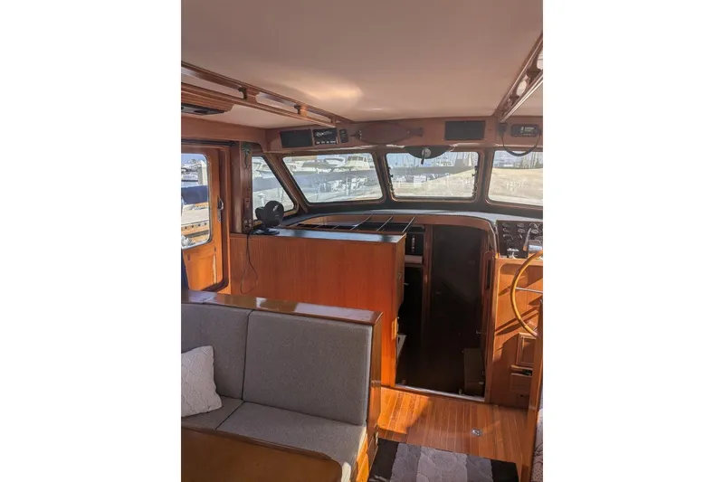 Slide: The Image of Interior of 1985 Kha Shing Spindrift 40 yacht with wooden helm and seating area. - 8