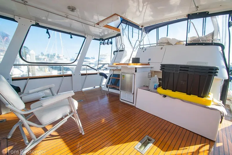 Slide: The Image of 1985 Spindrift 40 yacht interior with wooden flooring and seating area. - 25