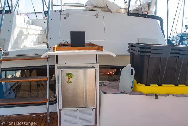 Slide: The Image of 1985 Spindrift 40 yacht interior with storage boxes and a small fridge. - 27