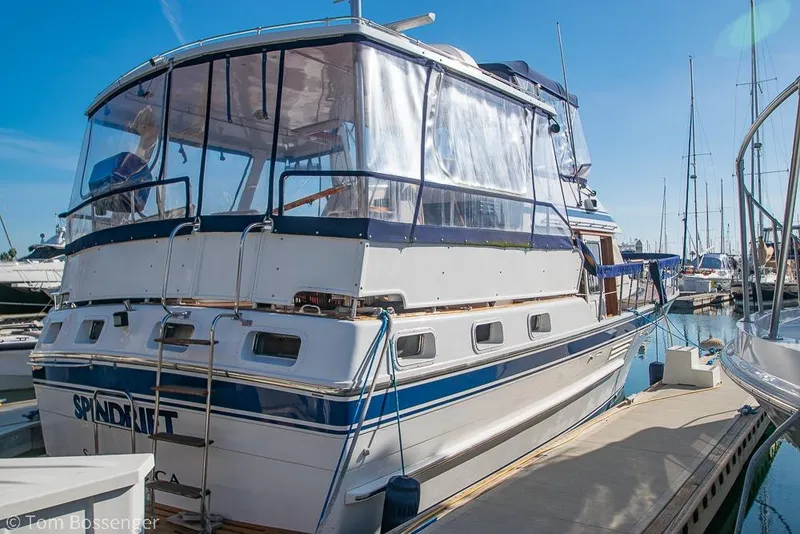 Slide: The Image of 1985 Spindrift 40 yacht docked at marina under clear blue sky. - 3