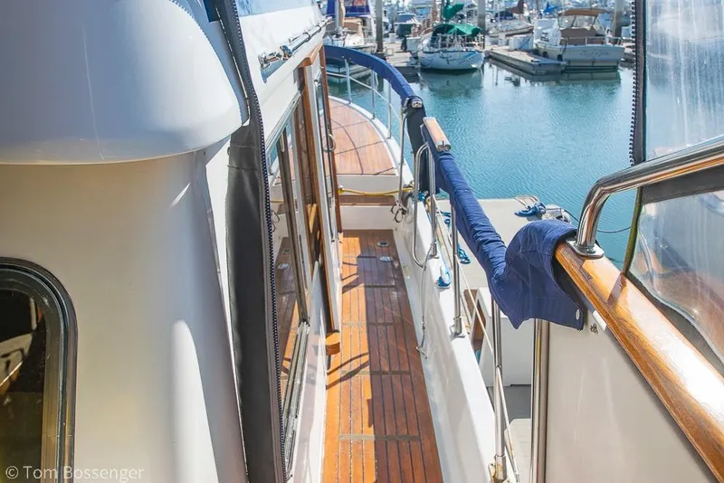 Slide: The Image of 1985 Spindrift 40 yacht deck with wooden flooring, docked at marina. - 35