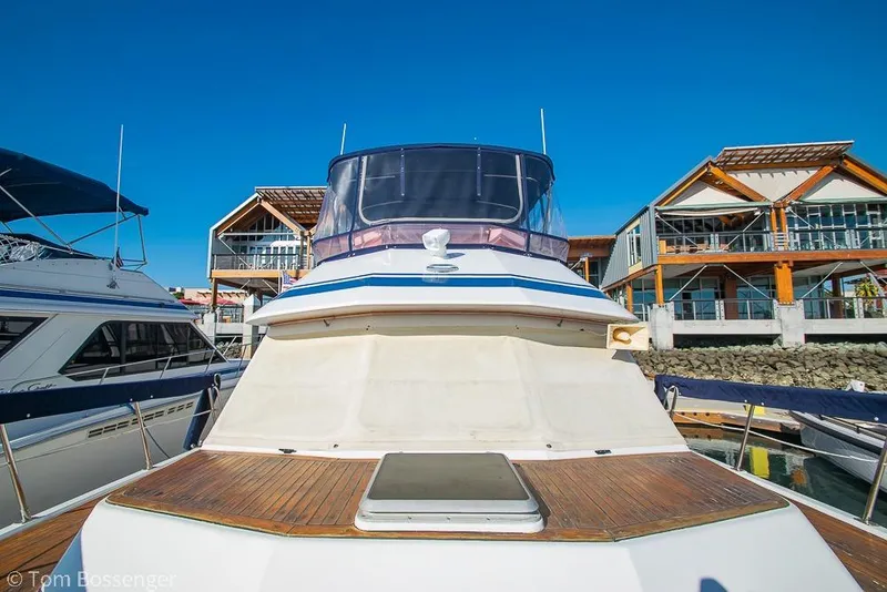 Slide: The Image of 1985 Spindrift 40 yacht docked at marina with modern buildings in background. - 39