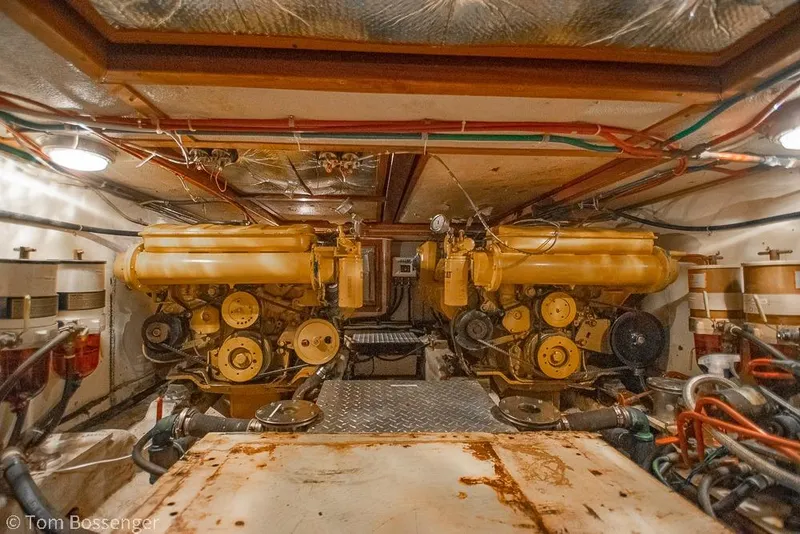 Slide: The Image of Engine room of a 1985 Spindrift 40 yacht with dual yellow engines. - 40