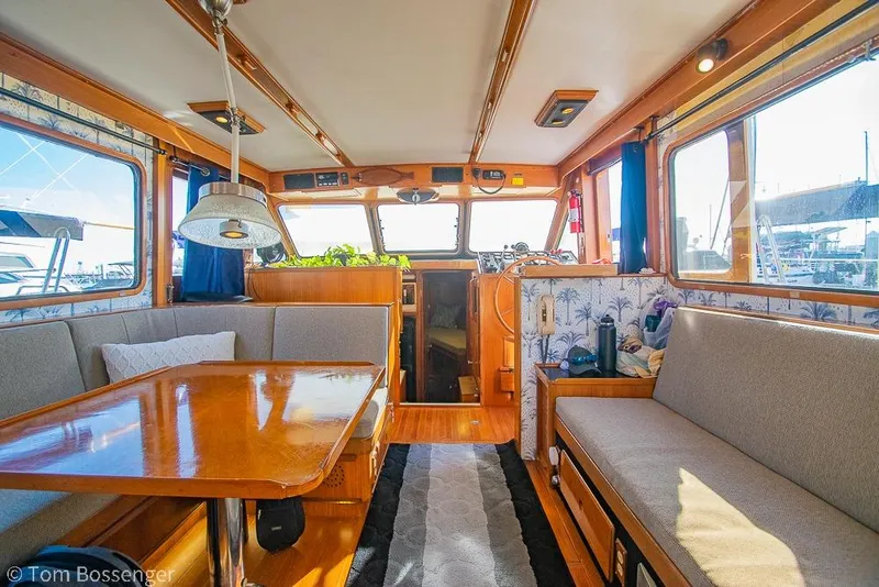 Slide: The Image of Interior of a 1985 Spindrift 40 yacht with wooden furnishings and seating area. - 7