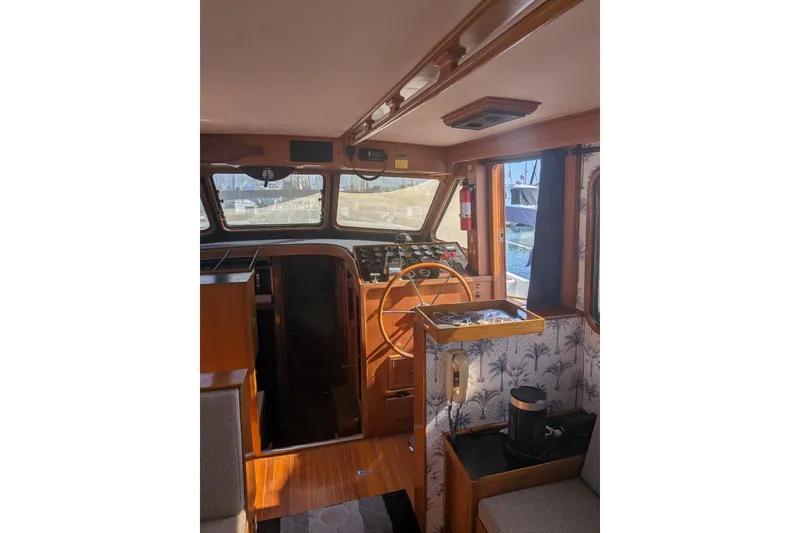 Slide: The Image of Interior of 1985 Kha Shing Spindrift 40 yacht with wooden helm and nautical decor. - 9