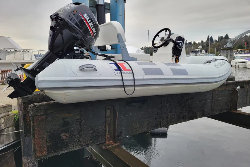 Slide: The Image of 2020 Inmar 330R-YS inflatable boat with Suzuki outboard motor on dock lift. - 11