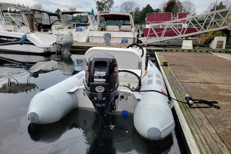 Slide: The Image of 2020 Inmar 330R-YS inflatable boat docked with a 25HP outboard motor. - 3
