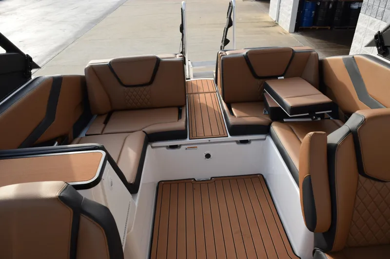 Slide: The Image of 2026 Yamaha Boats 252SD interior with luxurious brown seating and sleek design. - 11