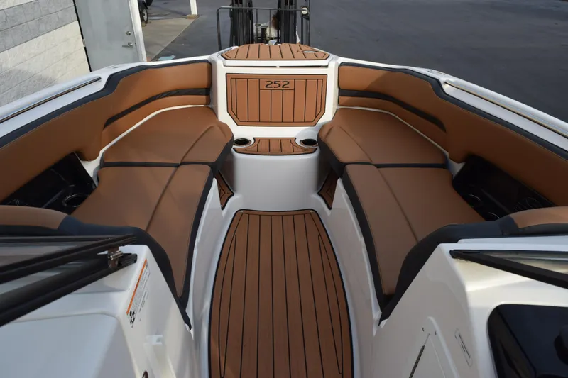 Slide: The Image of 2026 Yamaha Boats 252SD interior with brown seating and wood-style flooring. - 13